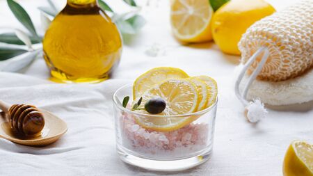Ingredients for body scrub of pink salt with lemon and olive oil, eco bio friendly cosmetic for skin care.の写真素材