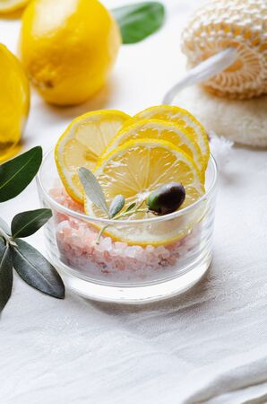 Ingredients for body scrub of pink salt with lemon and olive oil, eco bio friendly cosmetic for skin care.の写真素材