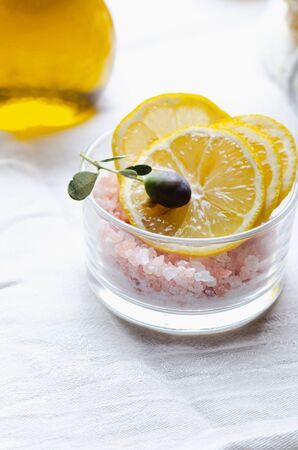 Ingredients for body scrub of pink salt with lemon and olive oil, eco bio friendly cosmetic for skin care.の写真素材