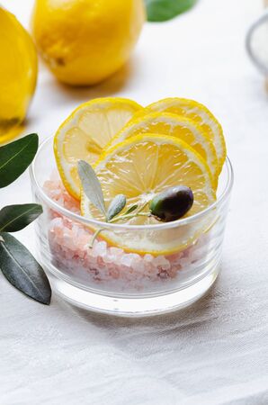 Ingredients for body scrub of pink salt with lemon and olive oil, eco bio friendly cosmetic for skin care.の写真素材