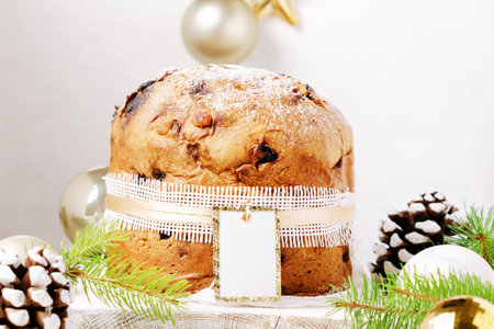 Panettone - Italian christmas sweet yeast bread on festive served plate on wooden table.の写真素材