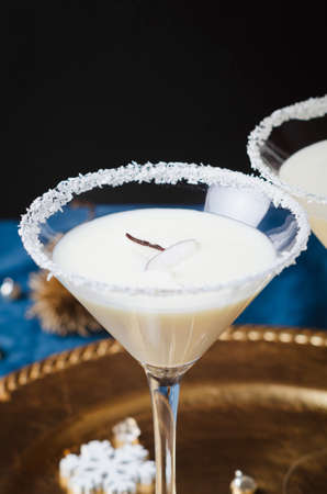 Winter cocktail with coconut flakes on gold tra. Christmas or New Year concept.の写真素材