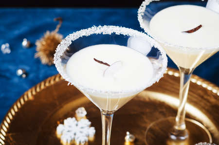 Winter cocktail with coconut flakes on gold tra. Christmas or New Year concept.の写真素材