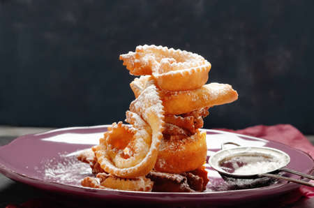 Italian carnival fritters galeno glove on purple plate.の写真素材
