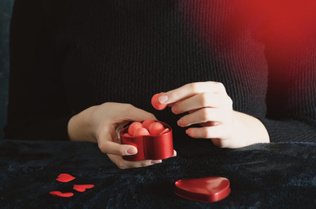 Young girl holds candy in the shape of a heart for Valentine's Day, Mother's Day, Father's Day and for your him/her.の写真素材