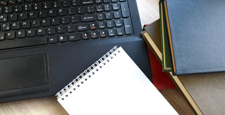 Flat lay with laptop, empty notepad and books. Concept of world quarantine by covid-19 and online...