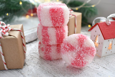 Christmas composition with peppermint candies and gifts on wooden background. Close up homemade traditional sweets. Greeting cardの写真素材