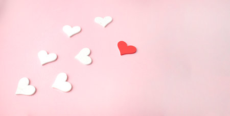 One red heart and white hearts on pinkの写真素材
