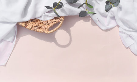 Mock up summer still life wedding scene with rattan basket, eucalyptus leaves and draped silk fabric...