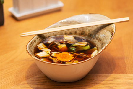 Chicken soup with noodles, shiitake mushrooms, carrots and cabbage, Asian cuisine. Vertical orientation, hard light.の写真素材