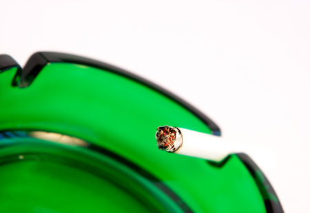 Spark of a decaying cigarette on a white backgroundの写真素材