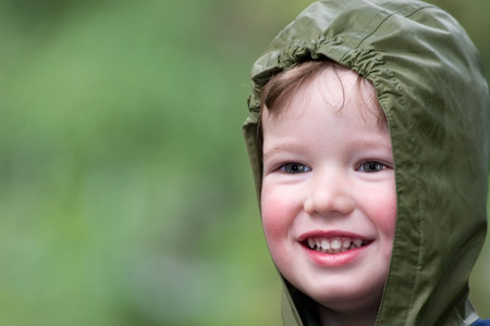 Cheerful child on walk in rainy dayの写真素材