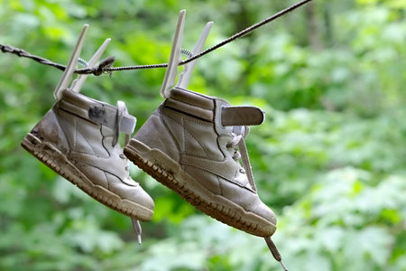 Got wet children's boots after walk on poolsの写真素材