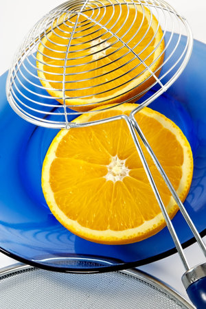 Half of orange on a blue plateの写真素材