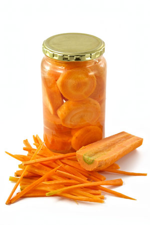 Carrots cut on slices and laid in glass containerの写真素材