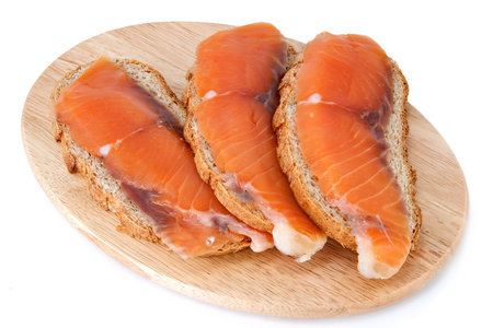 Juicy snack from slices salty salmon and crispbreadの写真素材