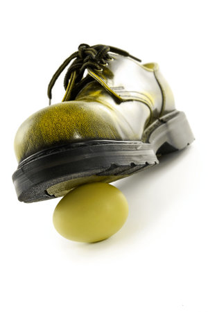 Boot crushing an egg-metaphor of violence, pressure, wreck and forceの写真素材