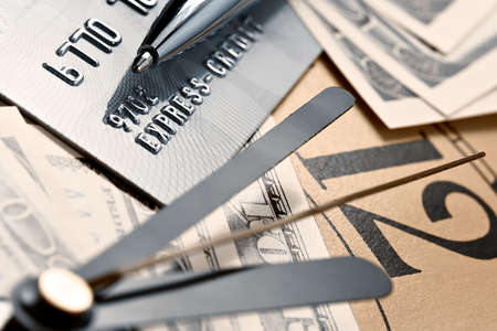 Credit card, time and dollars cash-connected among themselves attributes of the business worldの写真素材