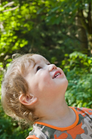 admired and surprised boy on walk in a scaffold in a sunny day