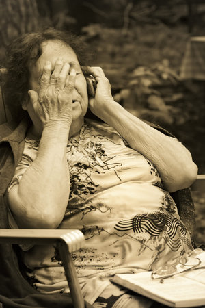  lonely old woman in deep depression speaks by mobile phone-thoughtfulness and sadness
