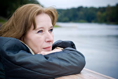 Portrait of attractive mature woman dreaming about something pleasantの写真素材