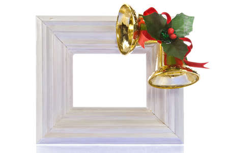 Christmas decoration-white wooden frame, bells and hollyの写真素材