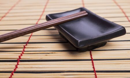 Bamboo mat, dish and chopsticksの写真素材