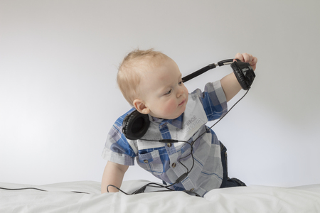An infant child with earphonesの写真素材