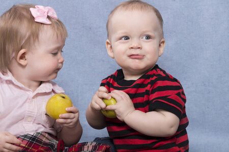 Two funny kids playing with apples. Retro styleの写真素材