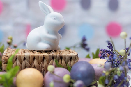 Funny Easter rabbit, colored eggs and flowers