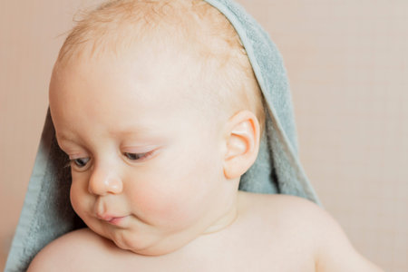 Cute baby boy after shower. Lovely infant kid in a bath towelの写真素材