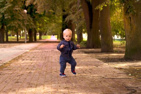 Funny toddler dancing in gangnam style. Outdoor shotの写真素材