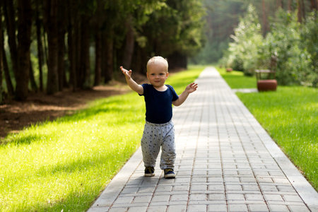 Baby's first steps.The first independent steps. Cute boy on the walk.の写真素材
