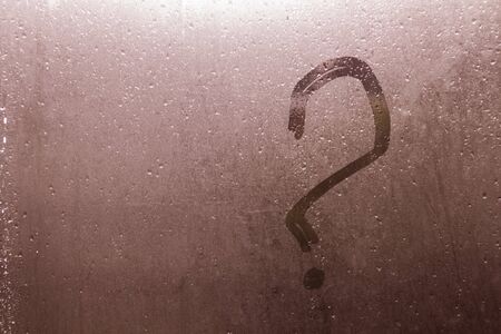 Autumn rain, the inscription on the sweaty glass - question mark. Copy spaceの写真素材