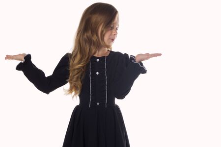 Surprised little girl holding something on the hands. Concept for adv. Isolated on white backgroundの写真素材