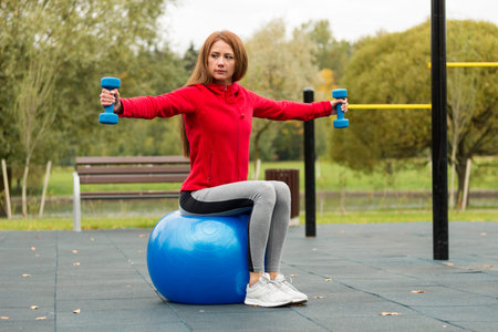 Fitness ,Healthy, Aerobics, Workout, Smiling Young Woman doing exercise with pilates ball on the...