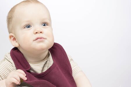 Funny Infant baby posing in bib. Copy space. Studio shotの写真素材