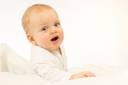 Bright portrait of adorable baby boy on the blue background