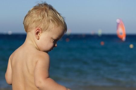 close up portrait of the baby on the beach. sea view. copy spaceの写真素材