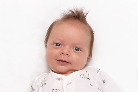 Cute Smiling newborn baby boy. Adorable infant looking at camera.の写真素材