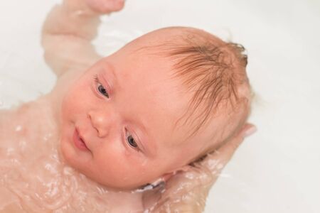 Close up face of cute and healthy baby boy smile during the bath time.の写真素材