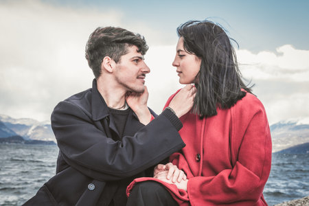 Romantic couple on the beach. Happy couple running on the beach on the background of the lake and...