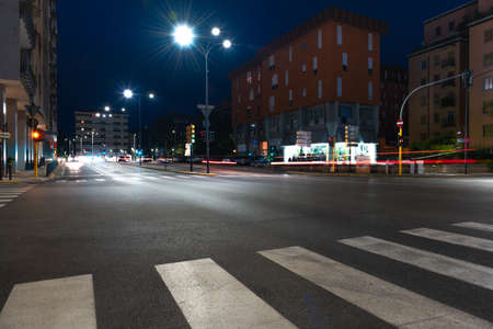Timelapse view of traffic at an urban night intersection. Urban movement in the Italian city in the evening.Time Lapse.の写真素材