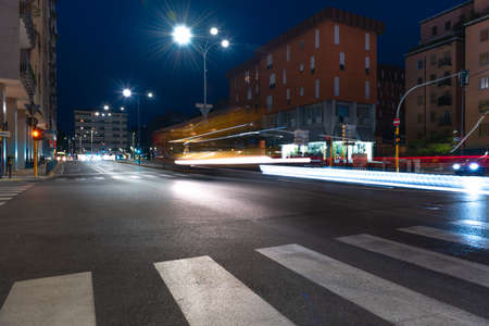 Timelapse view of traffic at an urban night intersection. Urban movement in the Italian city in the evening.Time Lapse.の写真素材