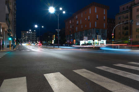 Timelapse view of traffic at an urban night intersection. Urban movement in the Italian city in the evening.Time Lapse.の写真素材