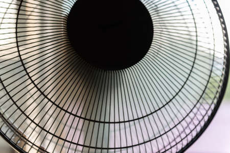 Time Lapse Rotary Fan. 4K UHD. Fan turbine in front of a window. The electric fan slows down and resumes movement.の写真素材
