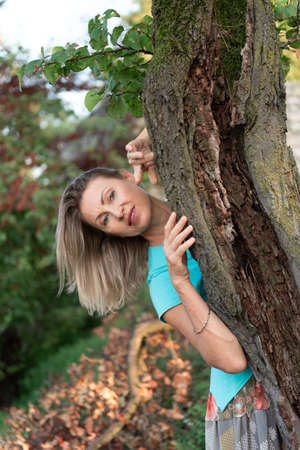 Portrait of adult woman with blond hair in natureの写真素材