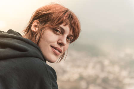 Portrait of a beautiful happy girl with red hair in the cave, lifestyleの写真素材