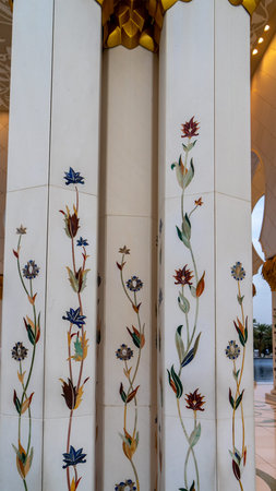 Mosaic of multicolored stones in form of flowers on white marble columns in Sheikh Zayed Grand...