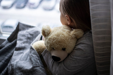 Little girl sleeping in bed with a teddy bear. The concept of children's sleep.